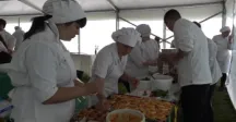 Alumnos de gastronomía ordenando alimentos para exponer